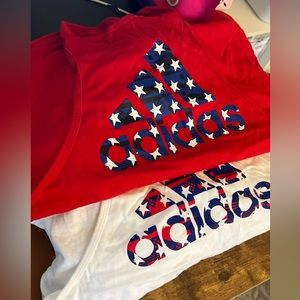 Never worn adidas small tanks. Two one red one white.